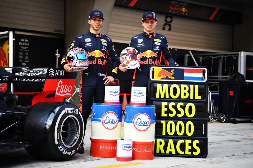 Max Verstappen of Netherlands and Red Bull Racing and Pierre Gasly of France and Red Bull Racing pose for a photo with heritage Esso and Mobil cans to commemorate the 1000th Formula One race during previews ahead of the F1 Grand Prix of China at Shanghai International Circuit on April 11, 2019 in Shanghai, China. (image courtesy Red Bull Racing) 