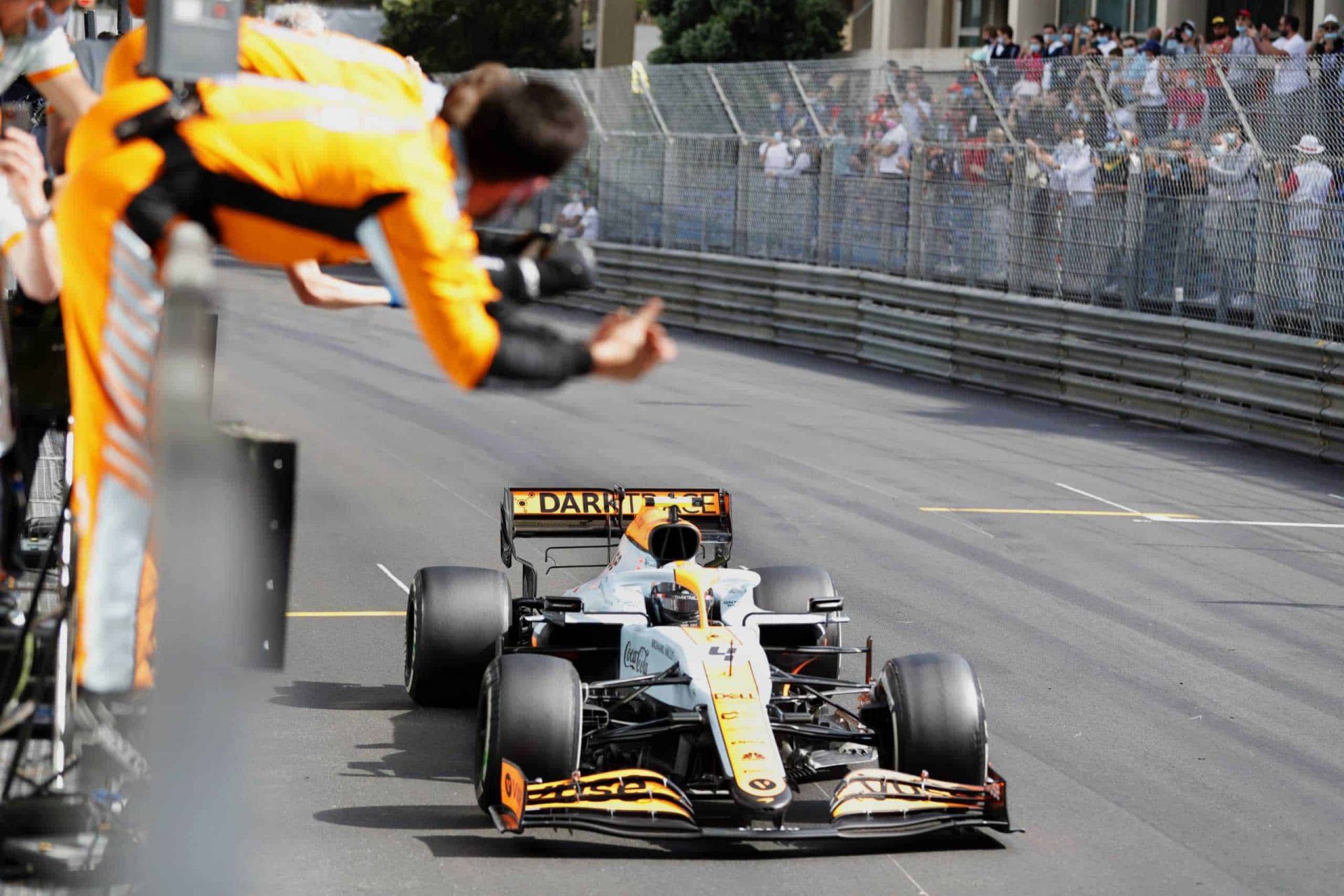 Lando Norris, McLaren MCL35M, 3rd position, crosses the line to the delight of his team on the pit wall (image courtesy McLaren press office)