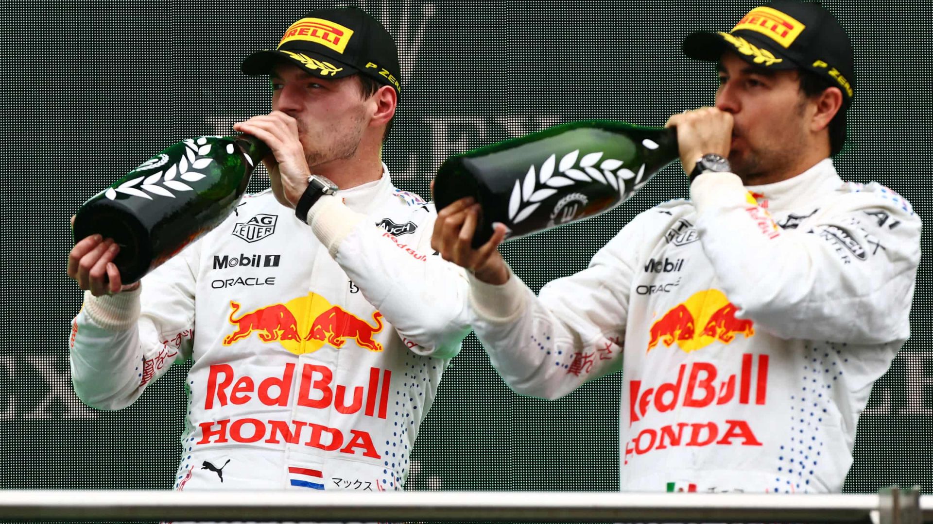 ISTANBUL, TURKEY - OCTOBER 10: Second placed Max Verstappen of Netherlands and Red Bull Racing and third placed Sergio Perez of Mexico and Red Bull Racing celebrate on the podiumduring the F1 Grand Prix of Turkey at Intercity Istanbul Park on October 10, 2021 in Istanbul, Turkey. (Photo by Mark Thompson/Getty Images) // Getty Images / Red Bull Content Pool // SI202110100653 // Usage for editorial use only //