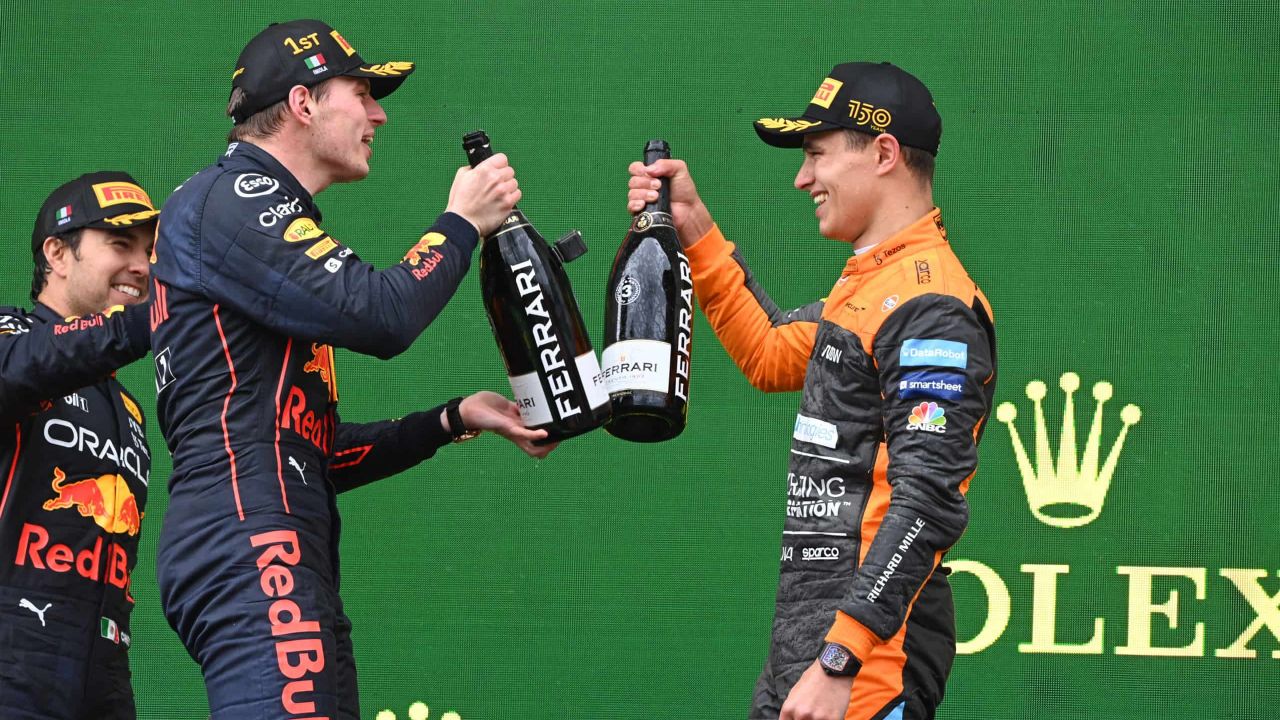 Max Verstappen, Red Bull Racing, 1st position, and Lando Norris, McLaren, 3rd position, celebrate with Champagne on the podium