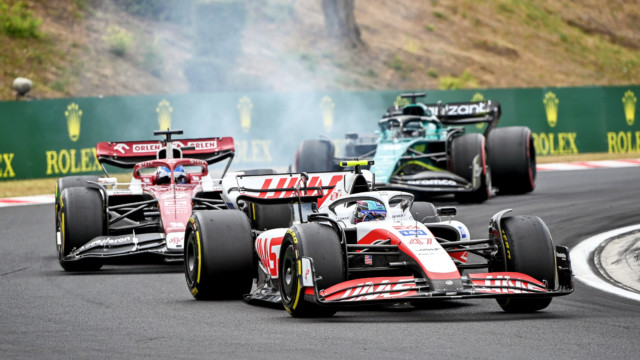 HUNGARORING, HUNGARY - JULY 31: Mick Schumacher, Haas F1 Team, leads Valtteri Bottas, Alfa Romeo C42, and Lance Stroll, Aston Martin AMR22 during the Hungarian GP at Hungaroring on Sunday July 31, 2022 in Budapest, Hungary. (Photo by Mark Sutton / LAT Images)