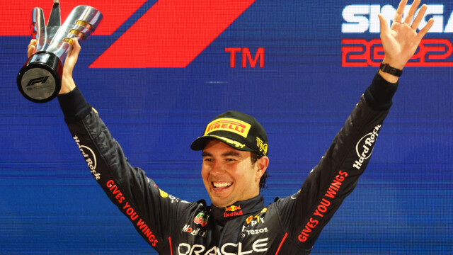 SINGAPORE, SINGAPORE - OCTOBER 02: Race winner Sergio Perez of Mexico and Oracle Red Bull Racing celebrates on the podium during the F1 Grand Prix of Singapore at Marina Bay Street Circuit on October 02, 2022 in Singapore, Singapore. (Photo by Clive Rose/Getty Images,) // Getty Images / Red Bull Content Pool // SI202210020458 // Usage for editorial use only //