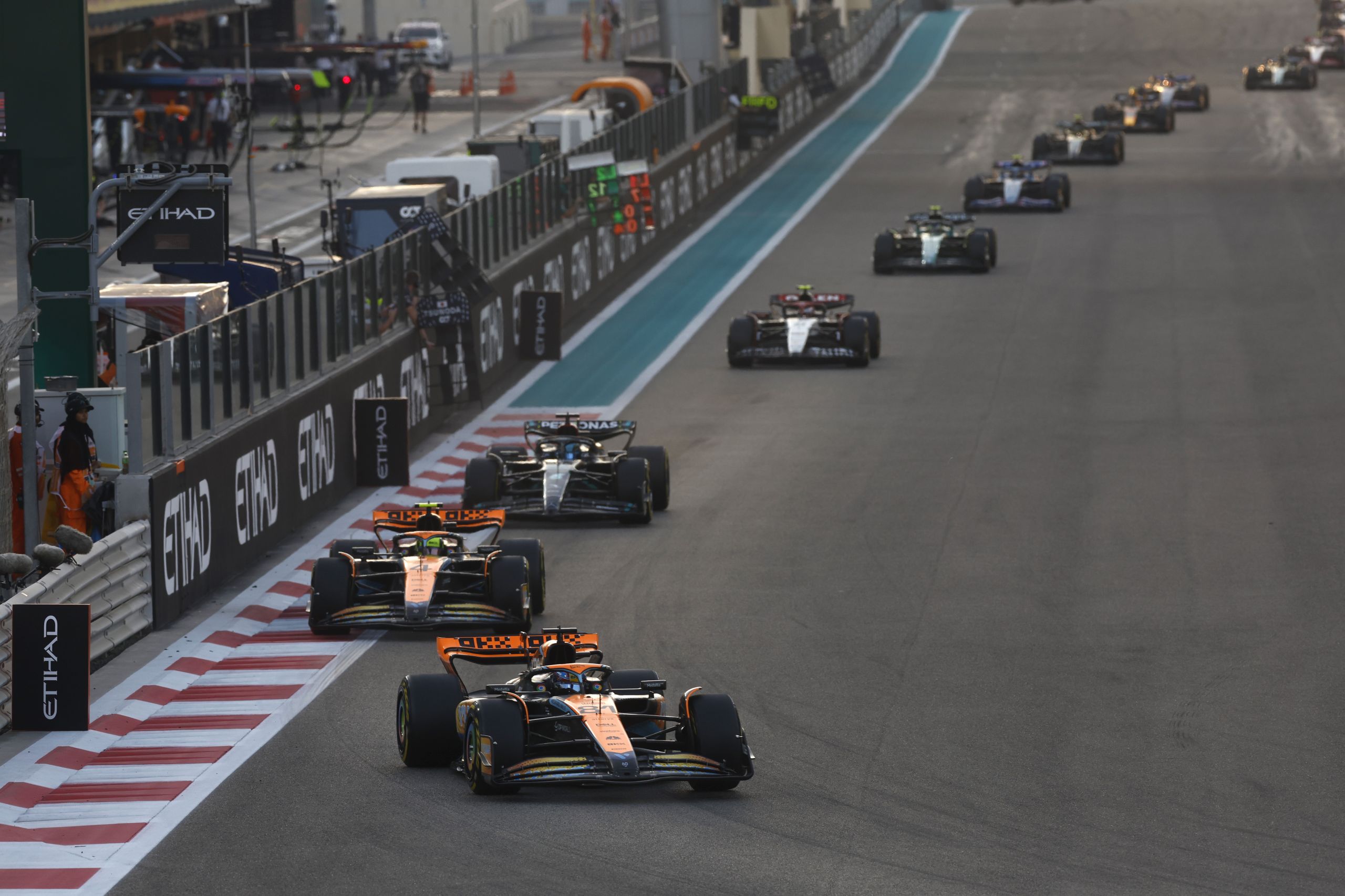 Oscar Piastri, McLaren MCL60, leads Lando Norris, McLaren MCL60, and George Russell, Mercedes F1 W14