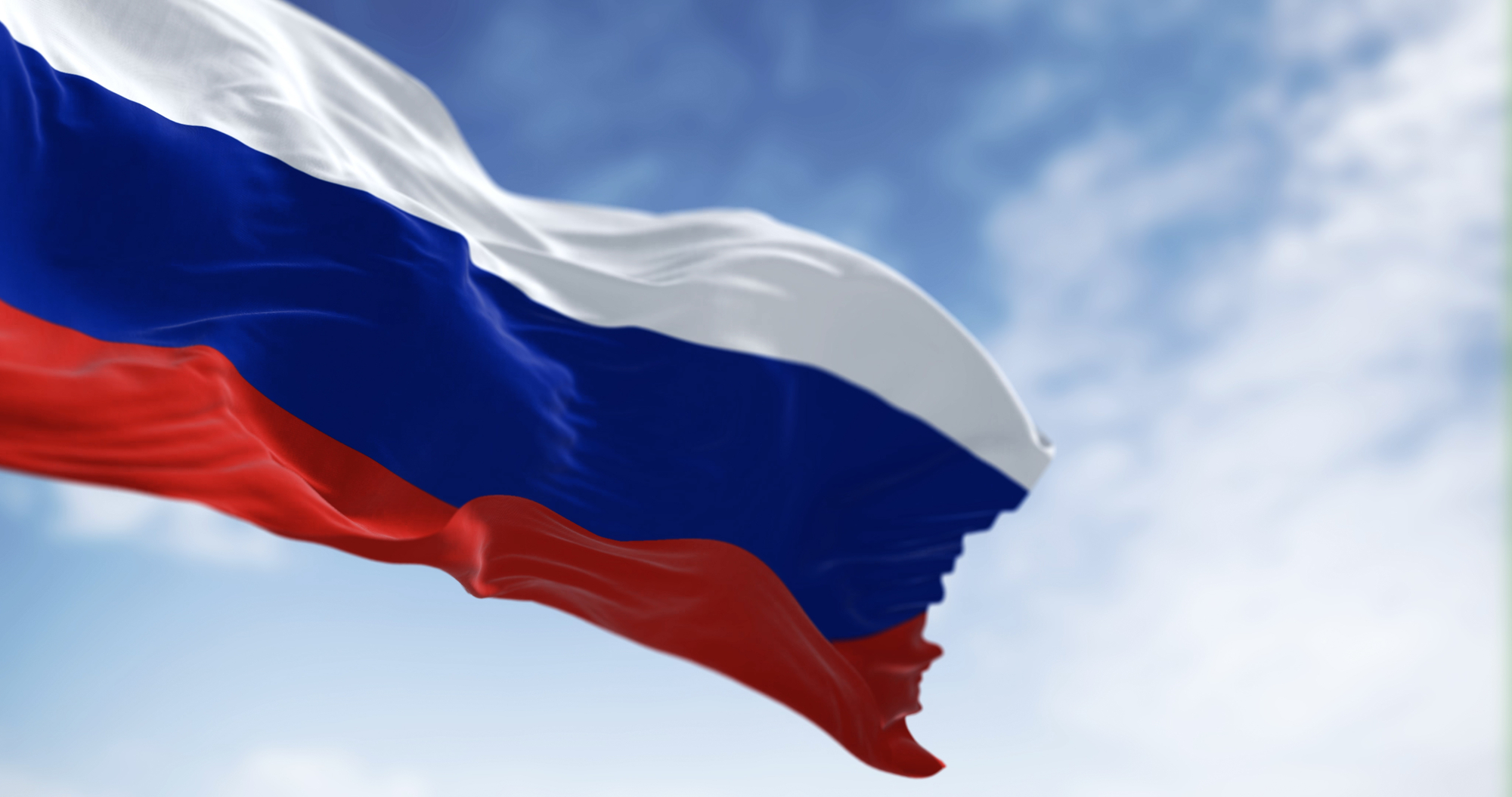 Three National Flags Of Russia Waving In The Wind On A Clear Day