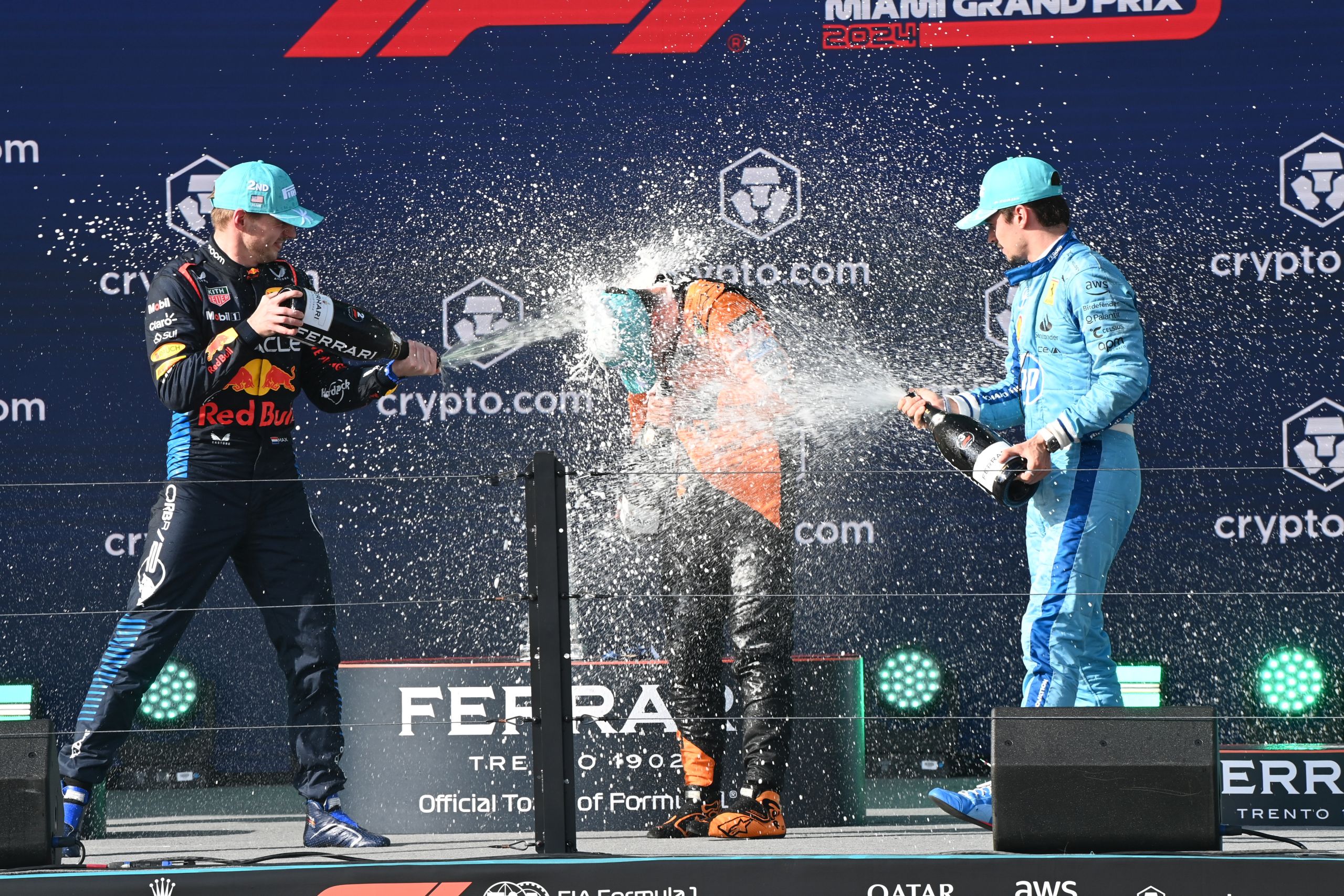 Max Verstappen, Red Bull Racing, 2nd position, Lando Norris, McLaren F1 Team, 1st position, and Charles Leclerc, Scuderia Ferrari, 3rd position, celebrate on the podium with Champagne