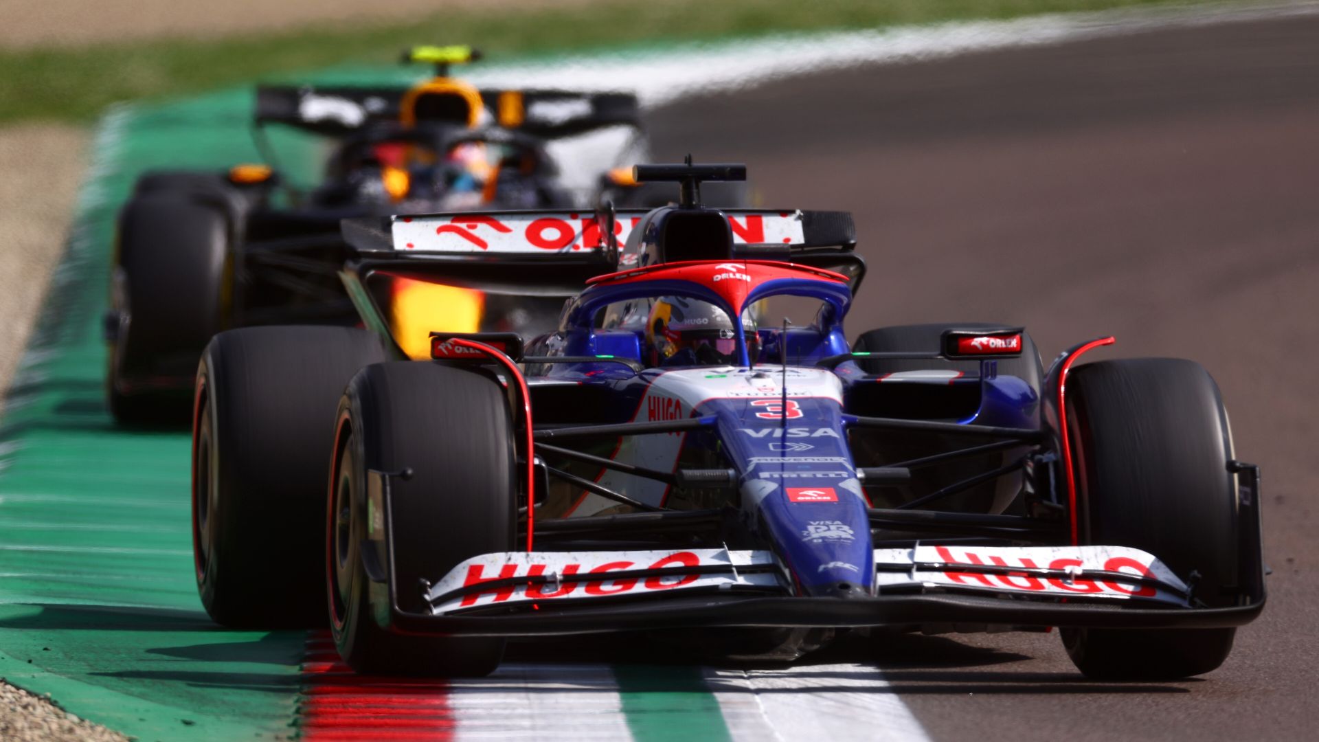 IMOLA, ITALY - MAY 19: Daniel Ricciardo of Australia driving the (3) Visa Cash App RB VCARB 01 leads Sergio Perez of Mexico driving the (11) Oracle Red Bull Racing RB20 during the F1 Grand Prix of Emilia-Romagna at Autodromo Enzo e Dino Ferrari Circuit on May 19, 2024 in Imola, Italy. (Photo by Lars Baron/Getty Images) // Getty Images / Red Bull Content Pool // SI202405190429 // Usage for editorial use only //