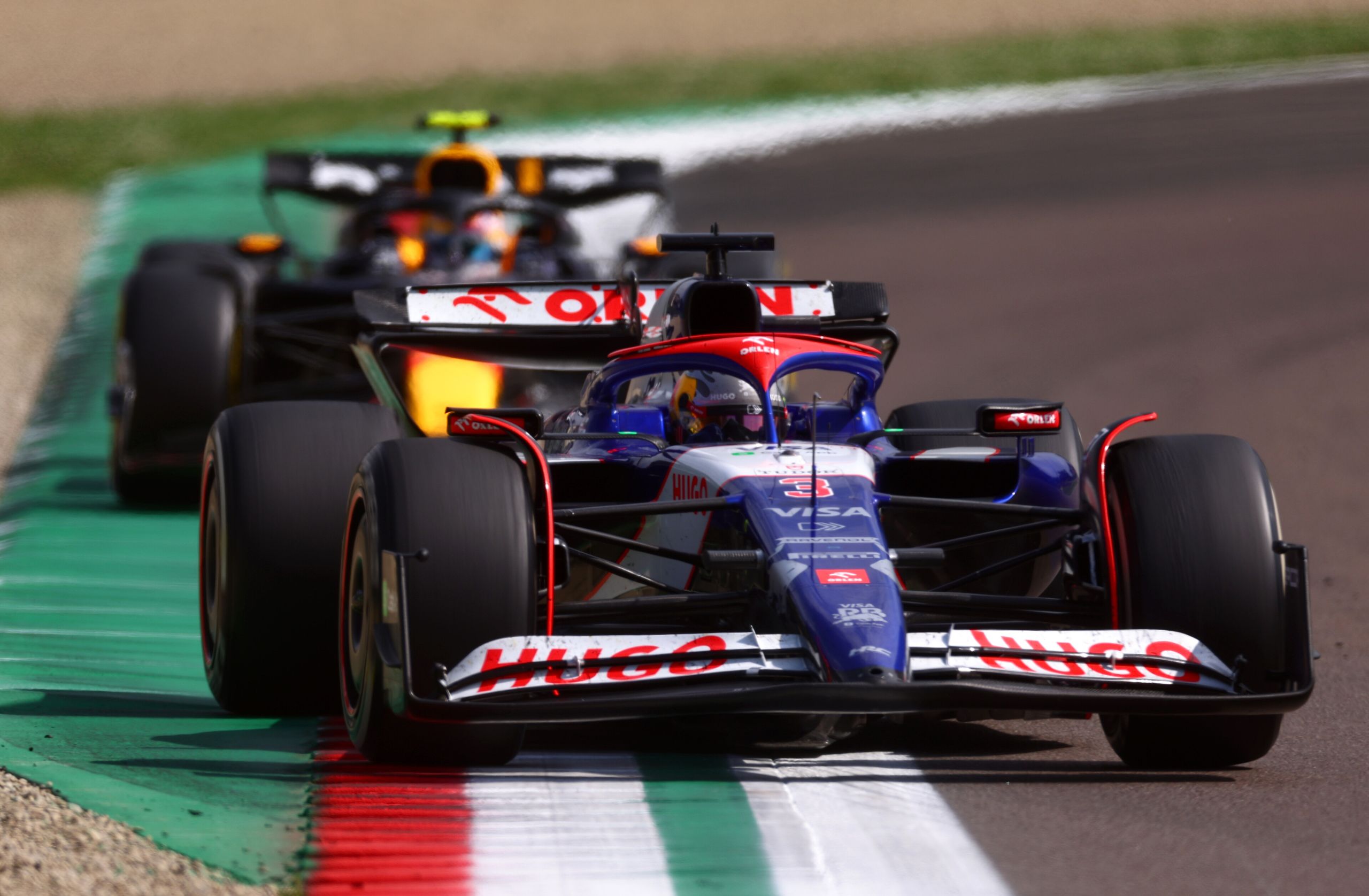 IMOLA, ITALY - MAY 19: Daniel Ricciardo of Australia driving the (3) Visa Cash App RB VCARB 01 leads Sergio Perez of Mexico driving the (11) Oracle Red Bull Racing RB20 during the F1 Grand Prix of Emilia-Romagna at Autodromo Enzo e Dino Ferrari Circuit on May 19, 2024 in Imola, Italy. (Photo by Lars Baron/Getty Images) // Getty Images / Red Bull Content Pool // SI202405190429 // Usage for editorial use only //