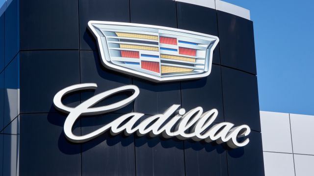 Cadillac Dealership Logo And Writing Over Blue Sky Background