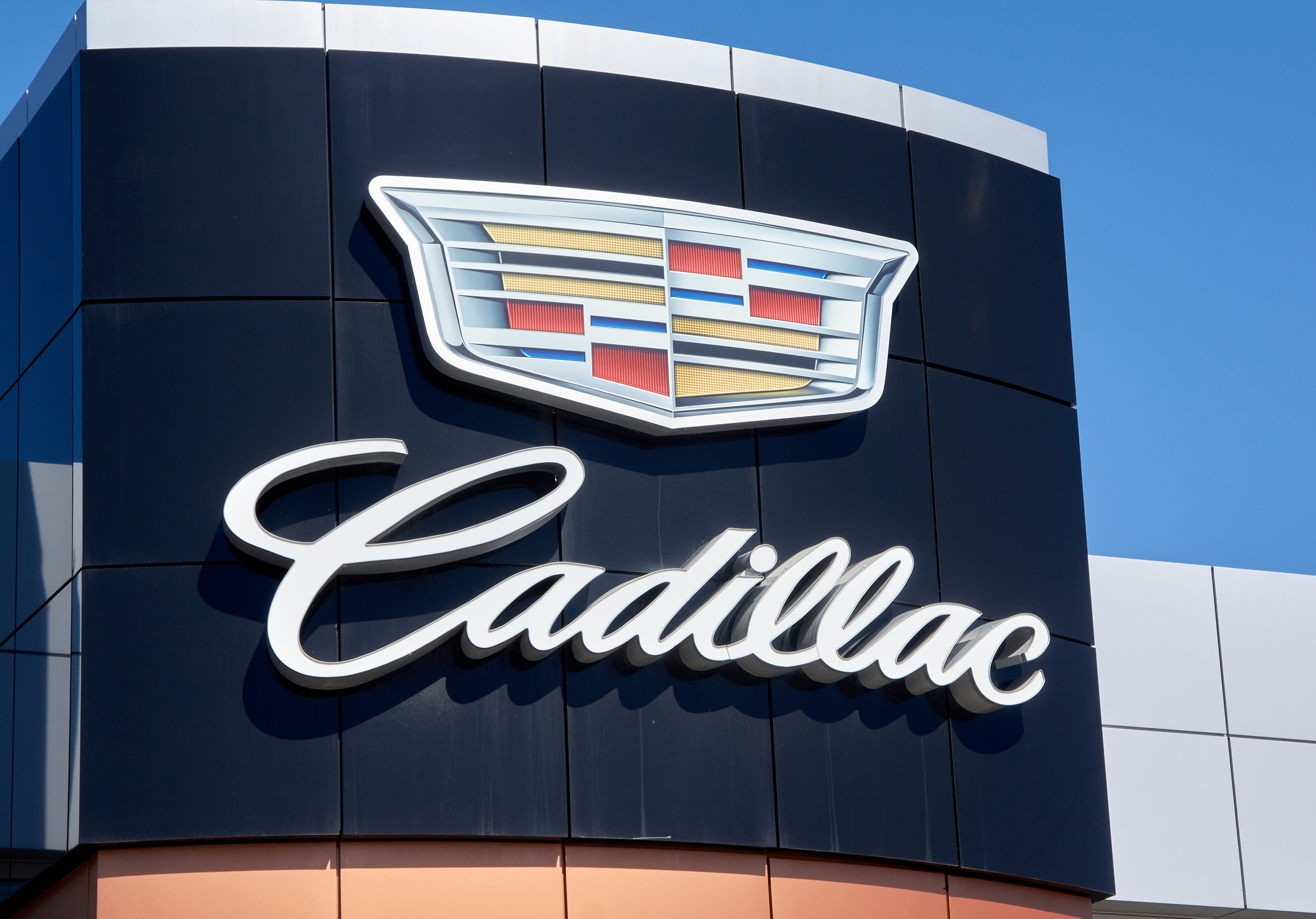 Cadillac Dealership Logo And Writing Over Blue Sky Background